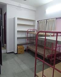 Shared room with bunk beds and storage shelves – ladies hostel near Hope College Coimbatore